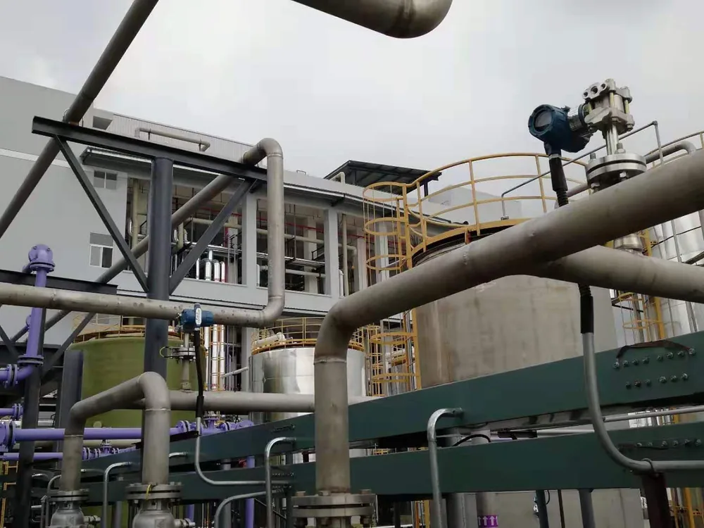 Process storage tanks in a chemical plant with a pressure transmitter mounted on a tank