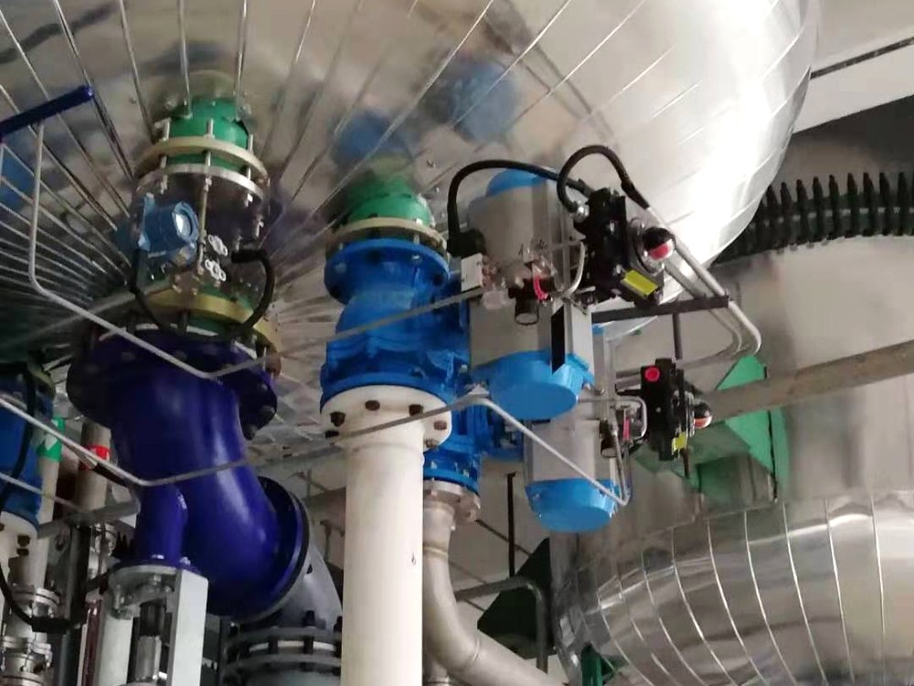 Process instruments and actuators on a plant pipe rack with signal cables running back to the control panel
