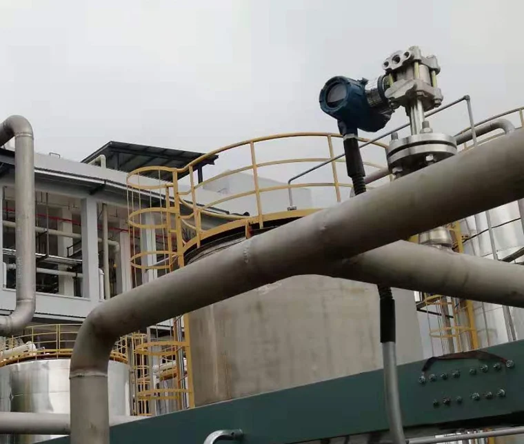Industrial pressure transmitter mounted on a process line against the sky at a chemical plant