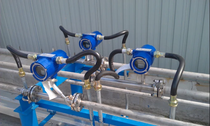 Three thermal mass flow meters installed on parallel compressed air lines outdoors