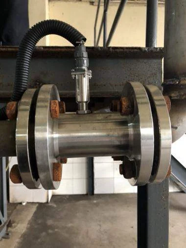 Flanged turbine flow meter with preamplifier head installed on a diesel line