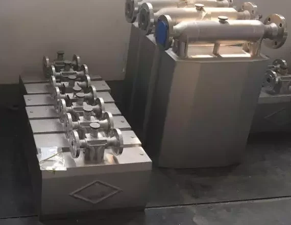 Straight-tube Coriolis mass flow meters of several sizes in a workshop