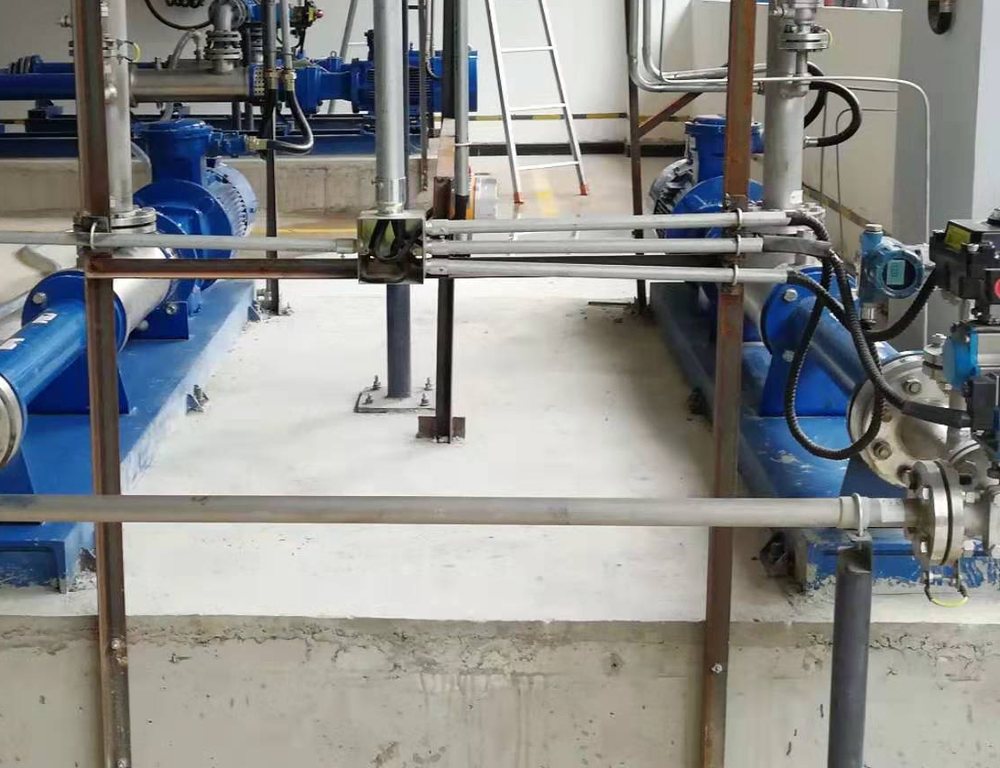 Pump room with centrifugal pumps and transmitters mounted on the discharge piping, part of a water pumping installation